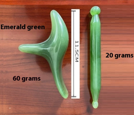 Emerald green massage tools with dimensions and weights, featuring a reflexology stick and curved massager on a wooden surface.